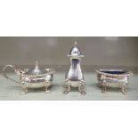 A three piece silver condiments set with gadrooned ornament, on paw feet  comprising a salt