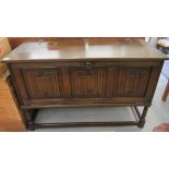 A modern dark stained oak finished coffer design music centre cabinet with a hinged top and a