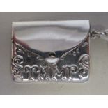A silver coloured metal envelope design pendant stamp case with a hinged cover