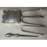 Three similar pairs of silver sugar tongs; a steel and embossed silver handled button hook; and a