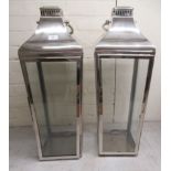 A pair of modern chromium finished hanging garden lanterns with glazed panelled sides  28"h  10"w