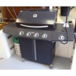 A modern gas fired barbeque in black casing, on casters  55"w with a re-usable LPG bottle