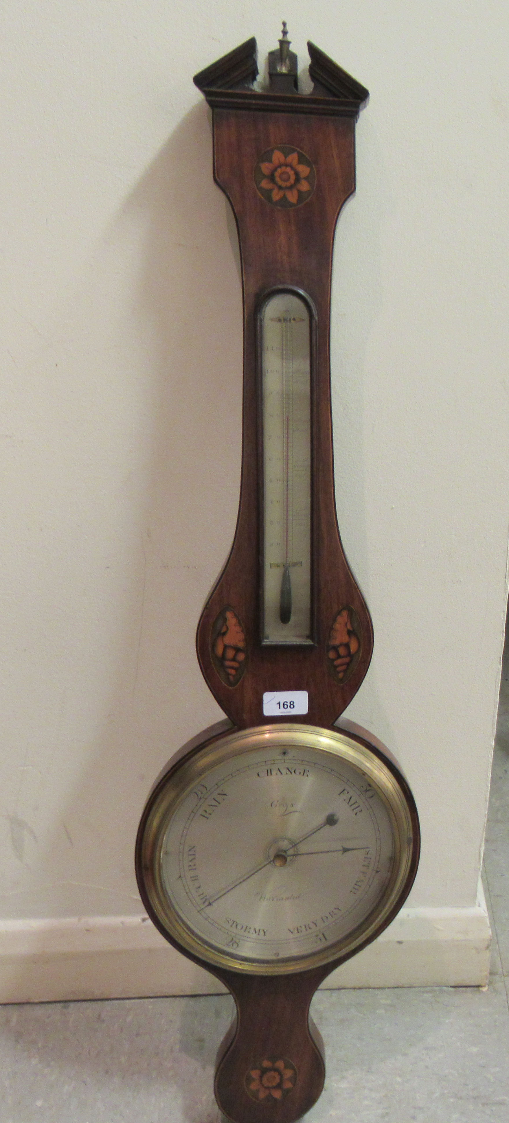 A 19thC string inlaid and marquetry mahogany cased wheel barometer with a broken arch pediment,