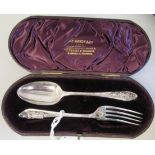 A late Victorian silver Christening spoon and fork, the decoratively engraved stems respectively