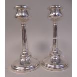 A pair of Art Nouveau inspired loaded silver candlesticks, each with a tulip design socket and a