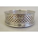 A silver wine coaster with bead bordered, latticed sides, on a turned mahogany base  B&Co