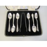 A set of six silver teaspoons and a matching pair of claw type sugar tongs  Barker Bros