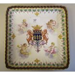 A late 19thC Continental porcelain dish, decorated in colours with an armorial, surrounded by