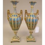 A pair of late 19thC Rudolstadt gilded porcelain, twin handled pedestal vase of ovoid form,