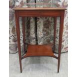 An early 20thC mahogany display table, the hinged lid with a bevelled glass panel, raised on square,