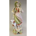 A late 19thC (probably Austrian) porcelain figure, a girl walking with a large dog at her side, on