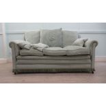 A modern three person settee with a level back and scrolled arms, upholstered in cushioned,