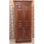 A mid 20thC mahogany one piece cabinet with a pair of three-quarter height panelled doors, over