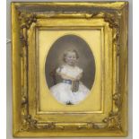 A mid Victorian oval portrait miniature, a little girl wearing a white lace trimmed dress, seated on