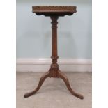 A 19thC style mahogany wine table with a galleried tray-top and later candle slide, over a ring