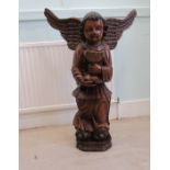 A Continental carved wooden angelic figure (of indeterminate age) holding a goblet  35"h