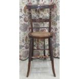 A 19thC carved, stained beech framed correction chair with a curved bar and horizontal splat, the