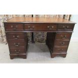 A modern mahogany twin pedestal, eight drawer desk, raised on bracket feet  30"h  48"w