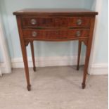 A mid 20thC mahogany serpentine front occasional table with two shallow drawers, raised on square,