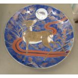 A 20thC Japanese porcelain charger, decorated with a deer under moonlight in a fairyland lustre