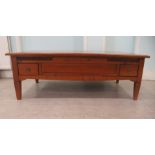 A modern cherrywood and figured veneer parquetry coffee table with box drawers, raised on short,