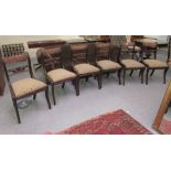 A set of six Regency mahogany framed dining chairs with carved splat backs, raised on sabre legs