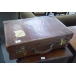 A 1930s rivetted moulded hide suitcase with reinforced corners  8"h  24"w