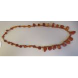 A rough-cut amber coloured necklace with uniform spacers, on a ring bolt clasp