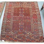 A Persian rug with geometric motifs, on a red ground  54" x 35"