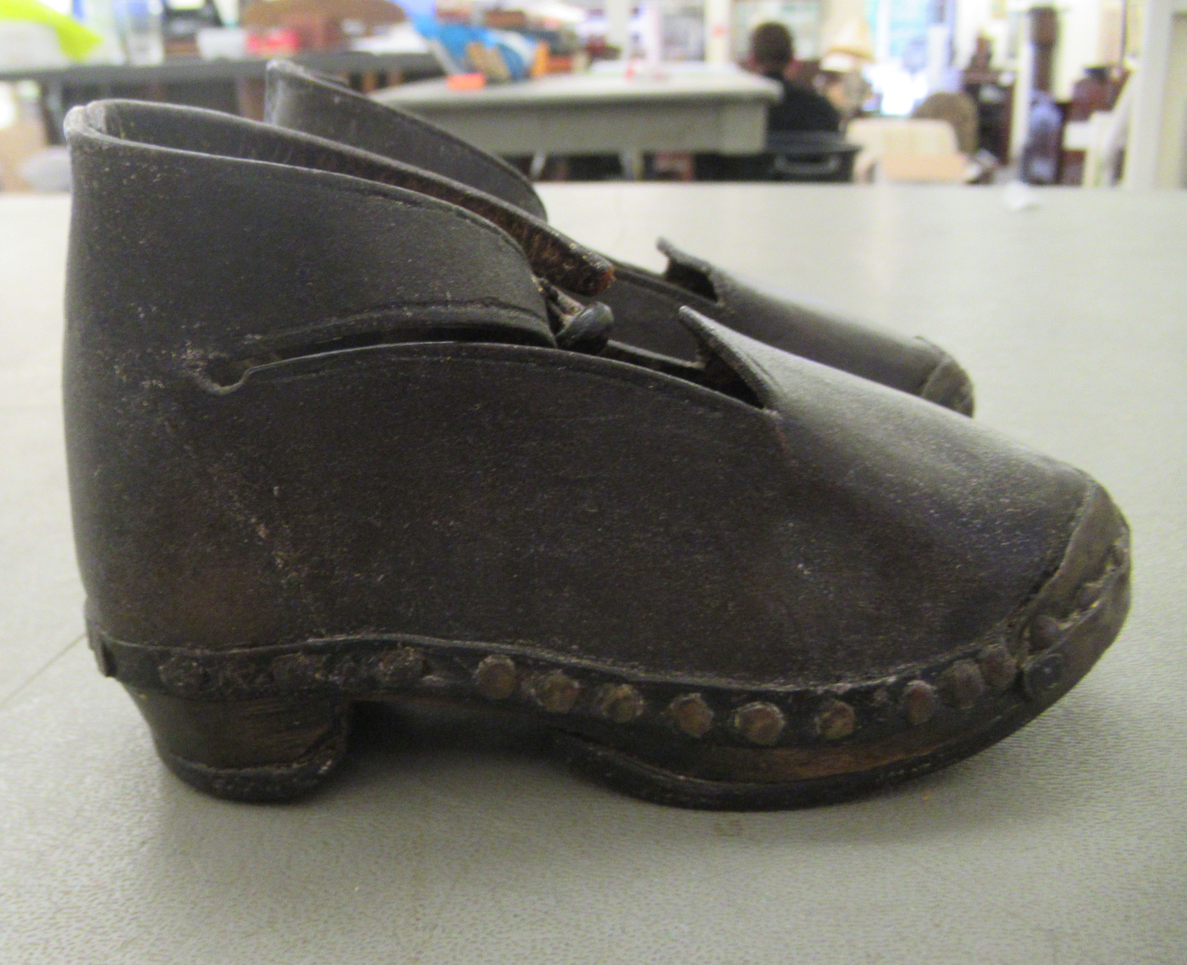 A child's pair of 19thC clogs with wooden soles and rivetted hide uppers