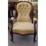 A late Victorian mahogany framed salon chair with a beige fabric upholstered back and seat, raised