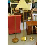Three dissimilar lacquered brass floorstanding standard lamps with angled arms  62"h