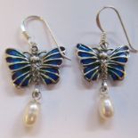 A pair of silver coloured metal, plique a jour pendant butterfly earrings