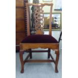 An early 19thC yewwood framed side chair with a yoke rail, ribbon splat and an upholstered, drop-