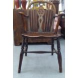 A 19thC ash and elm framed Windsor low hoop, spindled wheelback chair, the open arms on crook