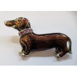 A silver coloured metal and coloured metal brooch, fashioned as a Dachshund