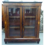A late Victorian string inlaid painted and rosewood finished pier cabinet, on a plinth and turned