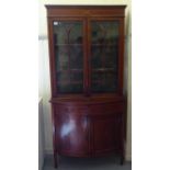 An Edwardian crossbanded and ebony inlaid cabinet bookcase, the upper section with two glazed doors,