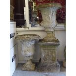 A pair of composition stone terrace pedestal vases, each moulded with a frieze of figures  21"h