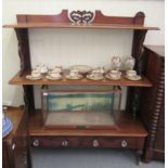 A late Victorian mahogany three tier buffet with fret carved end supports and a base drawer,