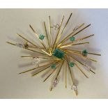 A gold coloured metal abstract spray brooch, variously set with emeralds and diamonds  stamped 18ct