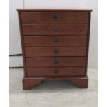 A modern mahogany three drawer fashioned as six facsimiles with provision to host CD's, raised