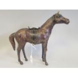 A moulded hide model, a standing saddled racehorse  13"h