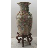 A modern Chinese porcelain vase, profusely decorated with pictorial cartouches, foliage and