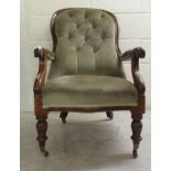 A late Victorian mahogany showwood framed open arm salon chair, part button upholstered in green