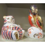 Two Royal Crown Derby china paperweights, viz. a Pelican  4.75"h; and a seated 'fat' cat  3"h