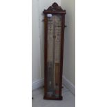 An early 20thC oak cased Admiral Fitzroy's barometer, faced by a painted backboard  41"h  8"w