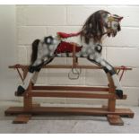 A mid 20thC overpainted rocking horse, on a pine underframe  37"h  47"L