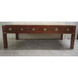 A modern military design brass bound yewwood coffee table, raised on square legs  16"h  48"w