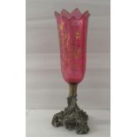 An early 20thC gilded cranberry coloured glass pedestal table candle holder, on a cast metal plinth